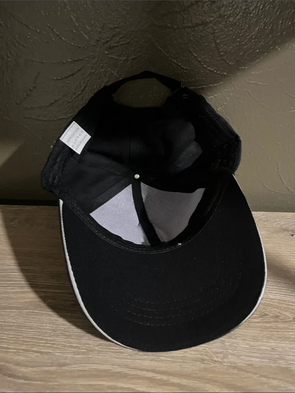 Black Baseball Cap With a Brown Logo And Adjustable Strap